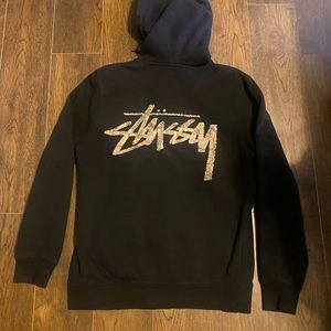 stussy full-zip with camo graphic